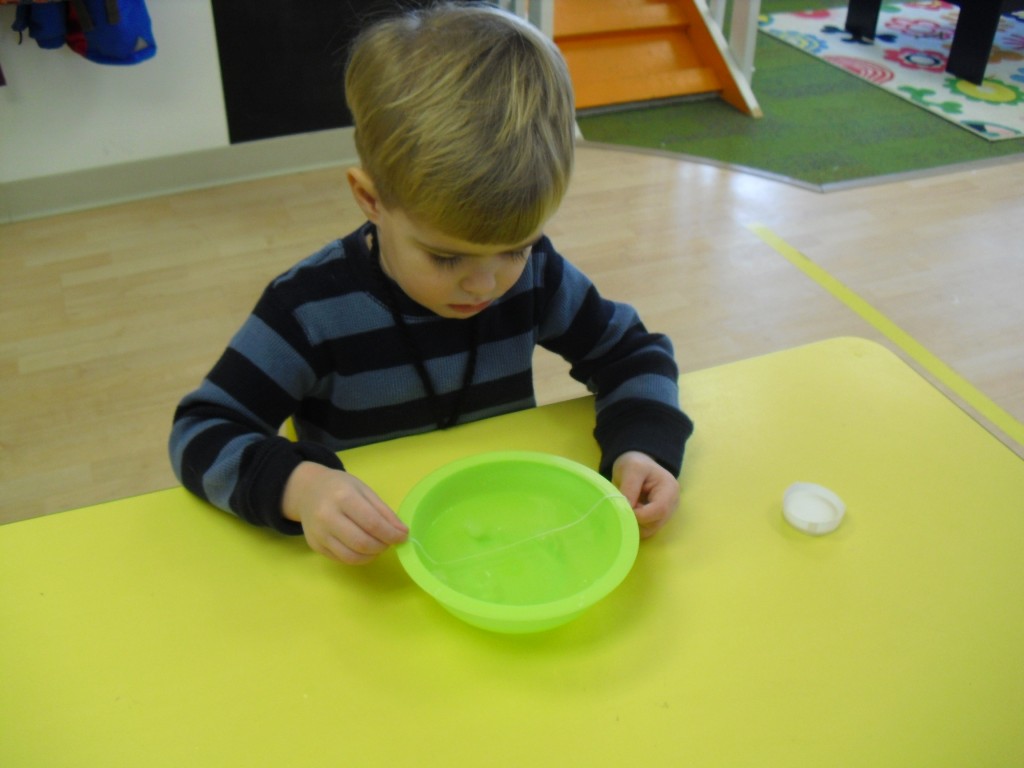 First we wanted to see if the string would stick to the ice cube. Many of the children predicted it would stick!  It did not!  Then we added salt......and presto the string did stick to the ice!